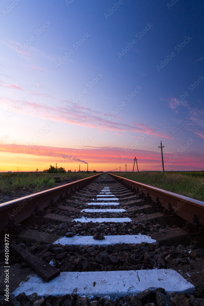 Railway in the steppe . photo right after sunset road leading to the distance