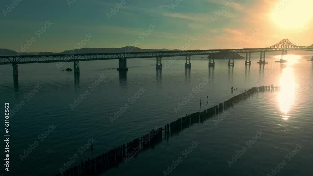 Aerial: Traffic on Richmond Bridge and calm ocean at sunset. Oakland, California, USA Aerial: Traffic on Richmond Bridge and calm ocean at sunset. Oakland, California, USA