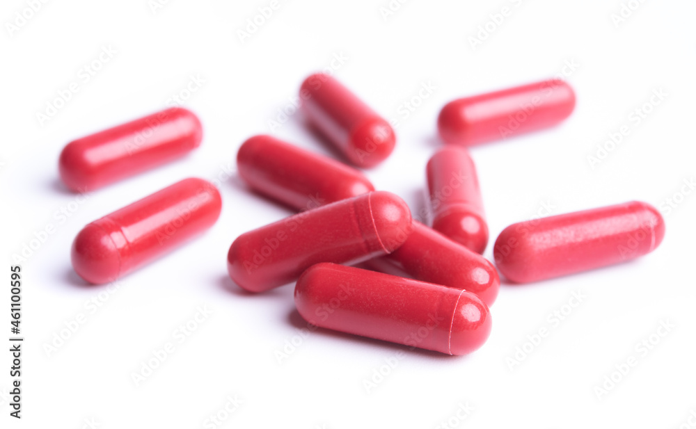 Red pills in capsules isolate on white background Red pills in capsules isolate on white background