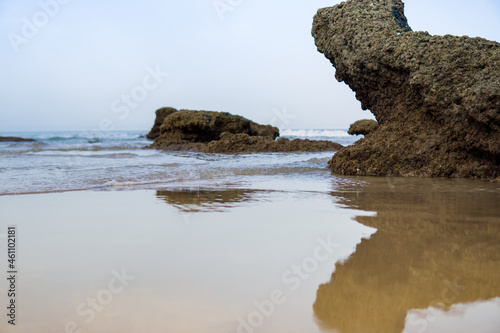 Beautiful ocean landscape, the coast of Cadiz, Conil, rocks on the sandy beach