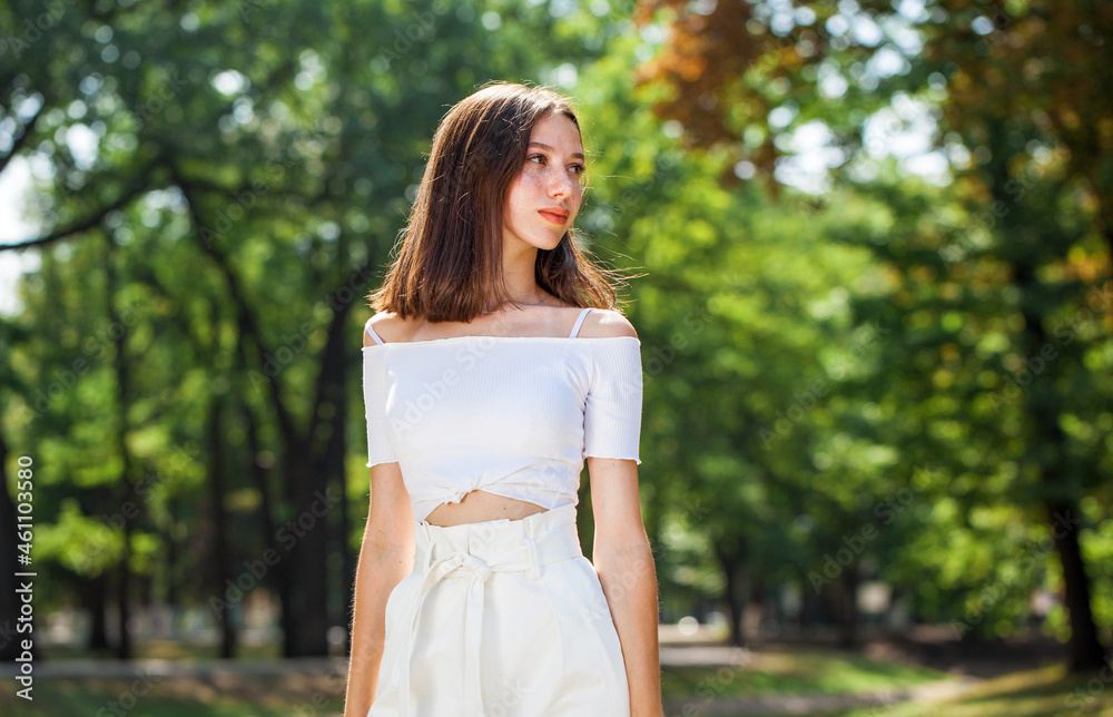 Young beautiful brown-haired girl with freckles on her face