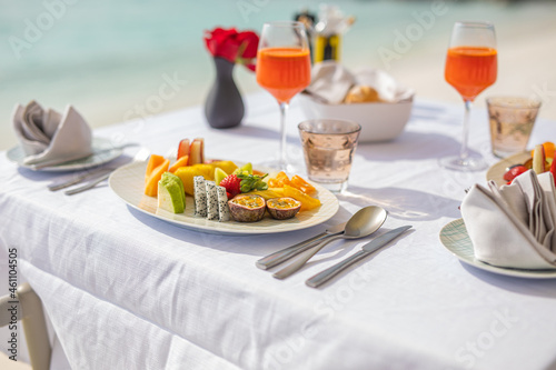 Luxury breakfast food on white table, with beautiful tropical sea view background, morning time summer holiday and romantic vacation concept, luxury travel and lifestyle, resort hotel fruit salad