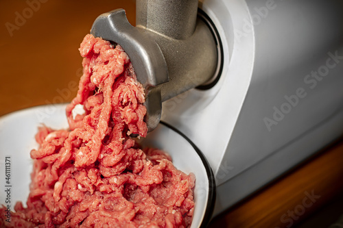 he process of twisting meat in a meat grinder. Minced pork and beef. Meat mince.