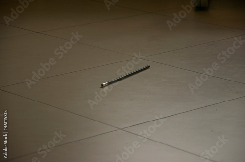 A black pencil on the floor.