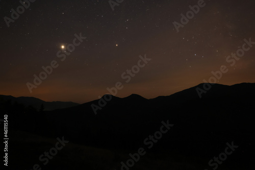 Picturesque view of mountain landscape and beautiful starry sky at night