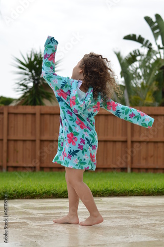 little girl twirling and dancing outdoors