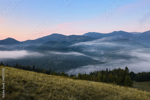 Fototapeta Naklejka Na Ścianę i Meble -  Amazing view of beautiful mountain landscape covered with fog