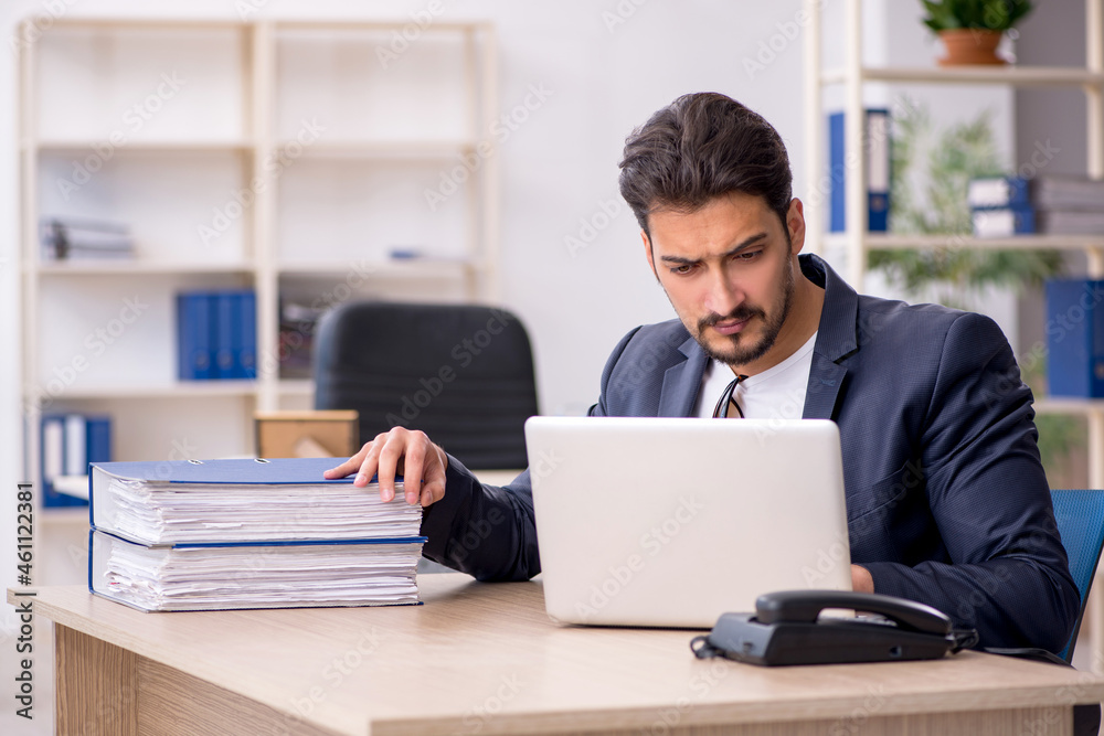 Young handsome employee working in the office Young handsome employee working in the office