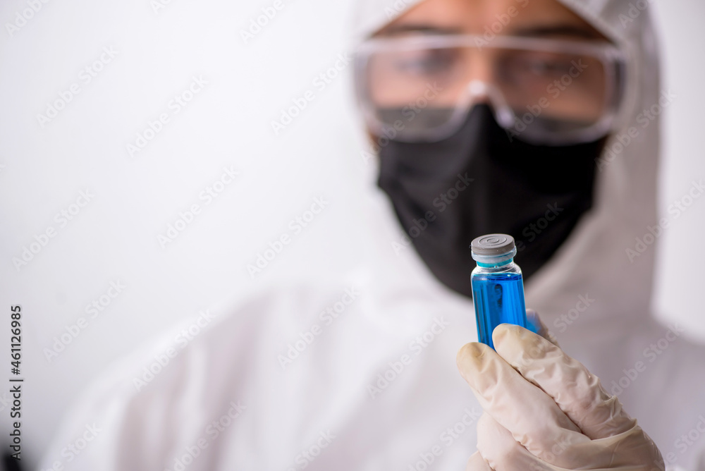 Young male chemist in drugs synthesis concept Young male chemist in drugs synthesis concept