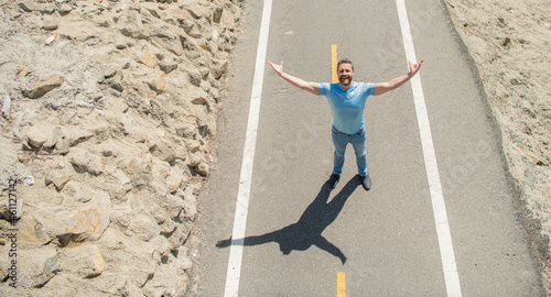 sense of freedom. healthy lifestyle. mature man looking up on road. full of happiness.