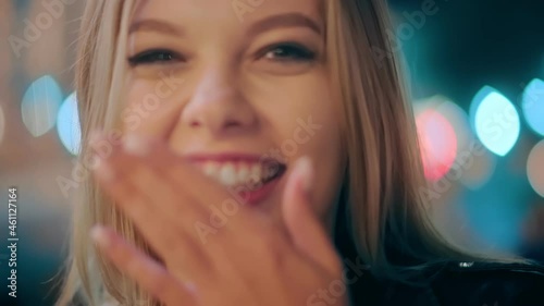 Happy carefree charming student girl having fun, showing tongue out and smiling, behaving in a naughty childish way with positive emotion. Portrait of sexy girl in night city