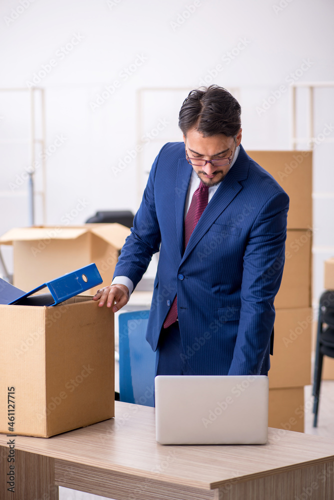 Young male employee in relocation concept Young male employee in relocation concept