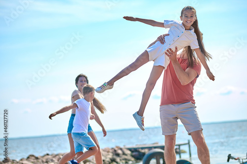 A family spending time on a beach and feeling awesome