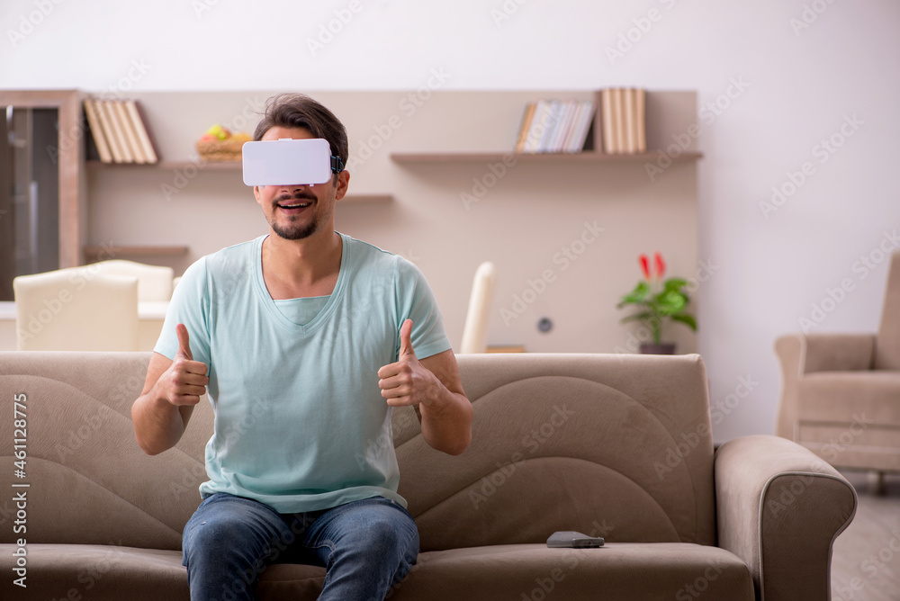Young man student wearing virtual glasses at home Young man student wearing virtual glasses at home