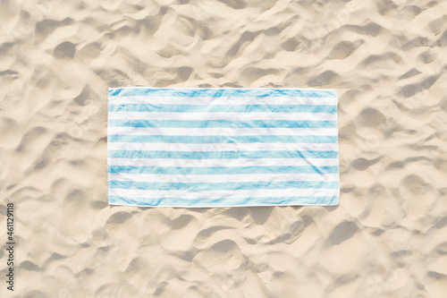 Fototapeta Naklejka Na Ścianę i Meble -  Striped beach towel on sand, aerial view