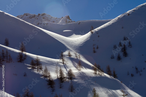 The mountain gorge is covered with snow under the rays of the sun