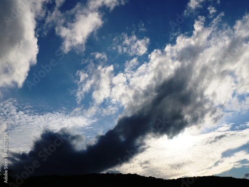 heavenly heights with thunderclouds and light laciness at different heights, a beautiful sky with a dramatic heating of clouds in a halo of sunlight