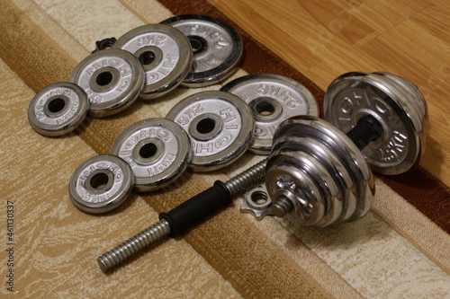 Metal collapsible dumbbells on the carpet