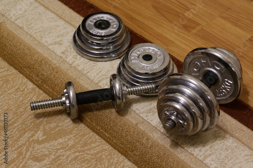 Metal collapsible dumbbells on the carpet