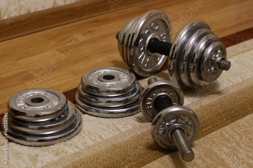 Metal collapsible dumbbells on the carpet