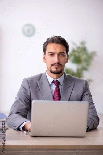 Young male employee working in the office