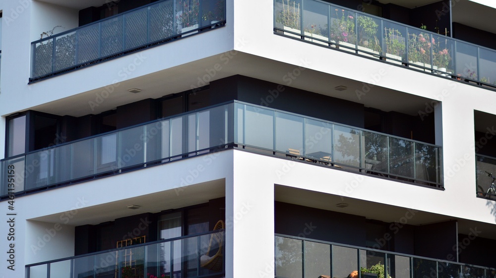 Fototapeta premium Modern apartment building. Modern urban architecture and details of building facade. Sunlight.