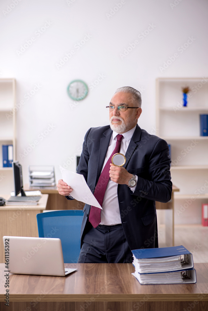 Old male employee working in the office Old male employee working in the office