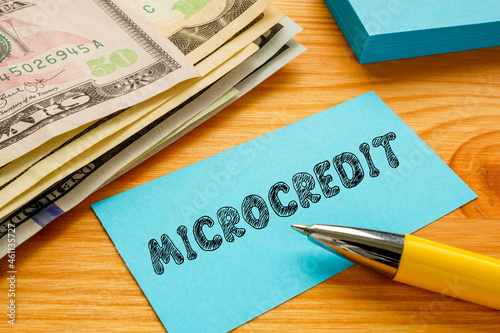 Business concept meaning MICROCREDIT with phrase on the piece of paper. photo