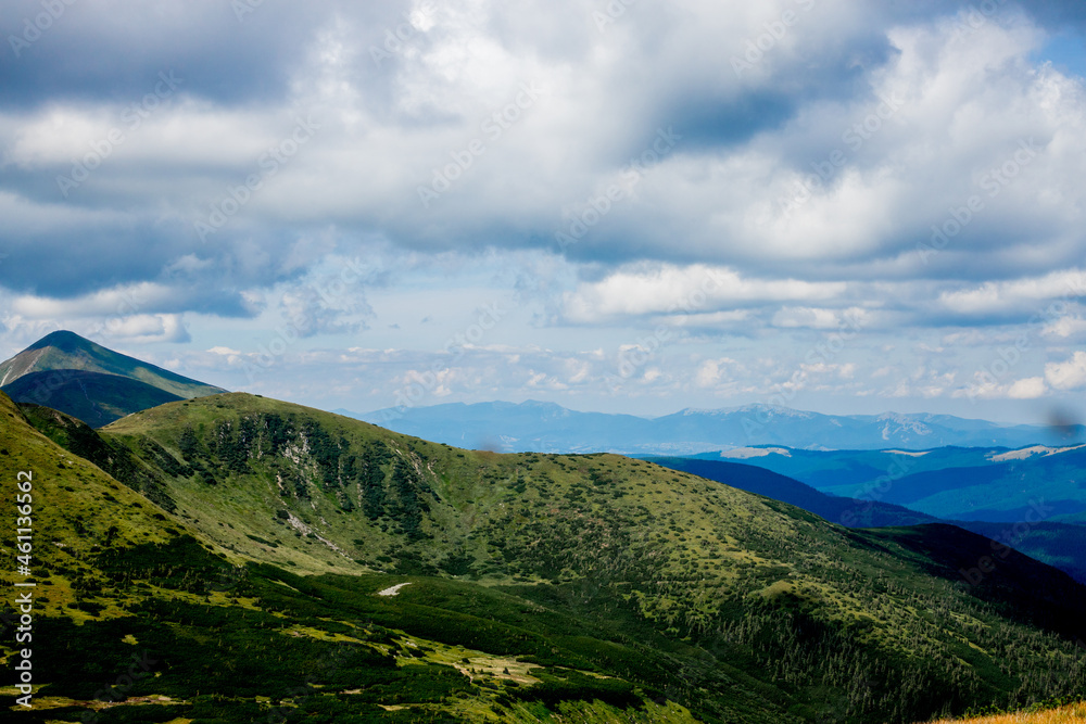 Incredibly beautiful panoramic views of the Carpathian Mountains. Peaks in the Carpathians on a background of blue sky