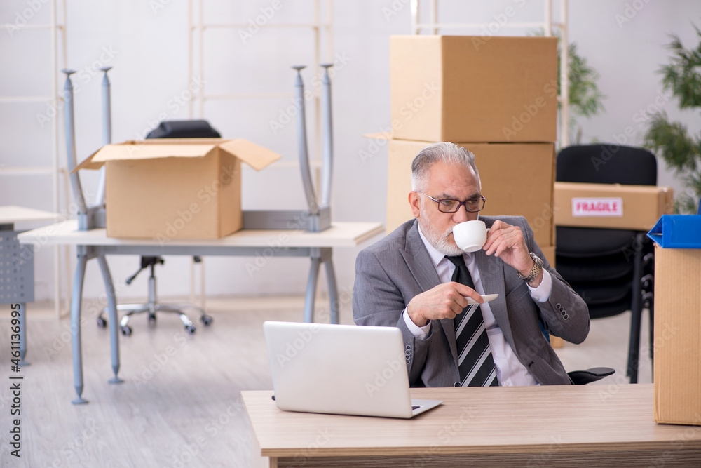Old male employee in relocation concept Old male employee in relocation concept