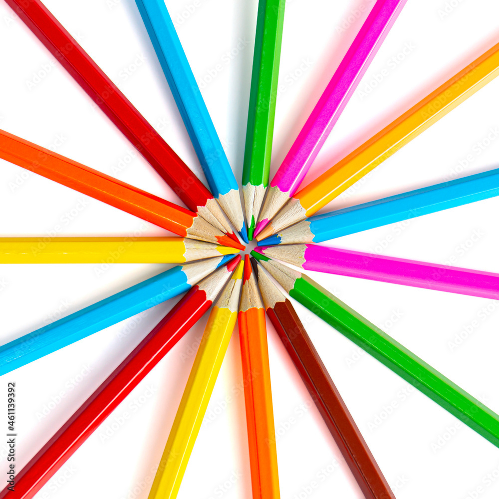 Colored pencils are laid out in a circle. Colorful pencils for drawing