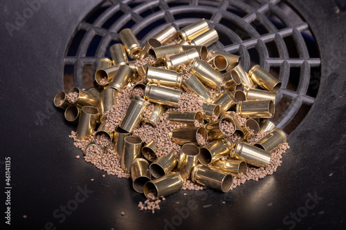 Reloading 9mm casings: sifting brass after cleaning and polishing  with tumbler using walnut shell media.
