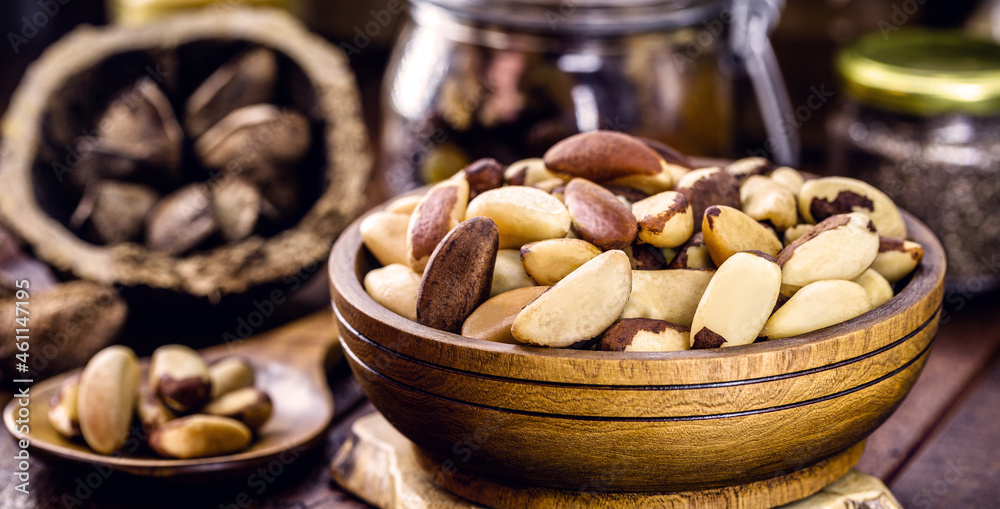 bowl with peeled Brazil nuts on a rustic table. healthy cooking ingredient bowl with peeled Brazil nuts on a rustic table. healthy cooking ingredient
