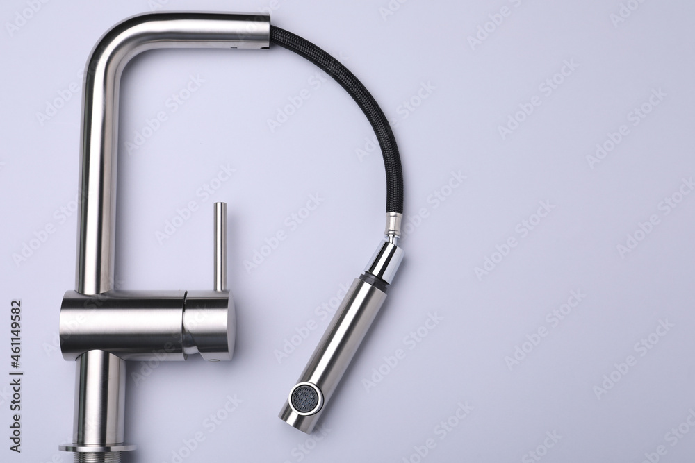 Modern pull out kitchen faucet on grey background, top view. Space for text Modern pull out kitchen faucet on grey background, top view. Space for text