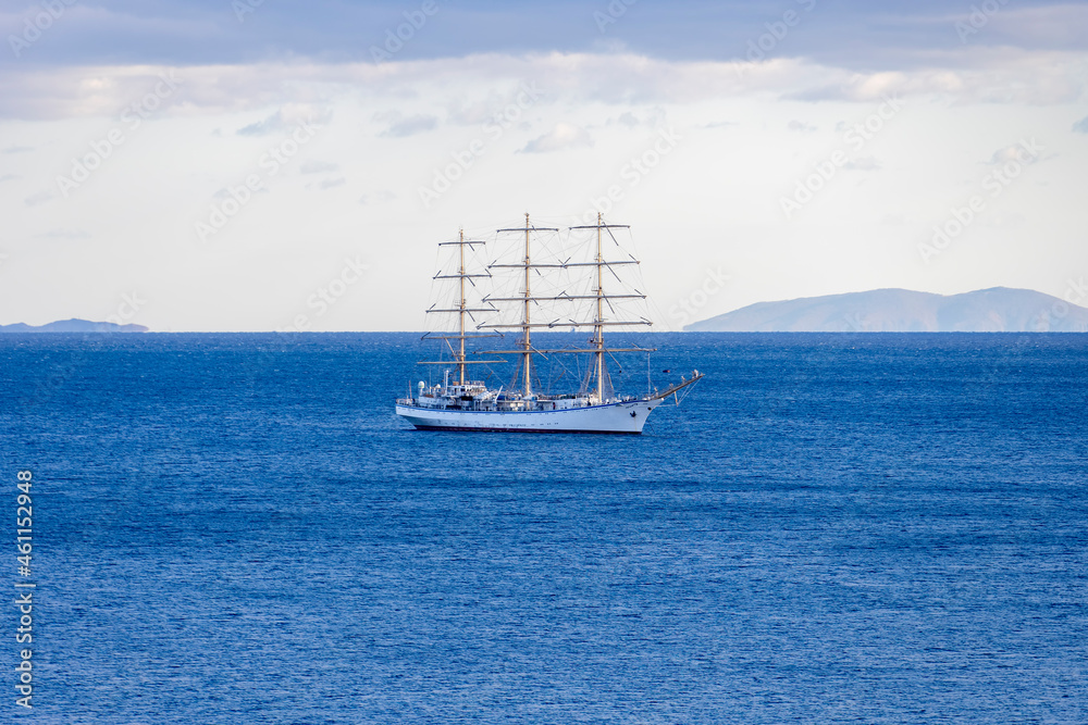 Seascape with a white sailboat on the horizon Seascape with a white sailboat on the horizon