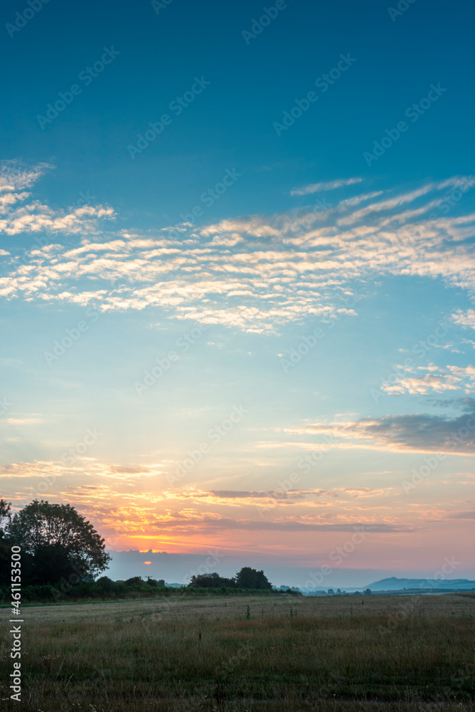 Summer sunrise and glowing clouds,Wilton,Wiltshire,England,United Kingdom. Summer sunrise and glowing clouds,Wilton,Wiltshire,England,United Kingdom.