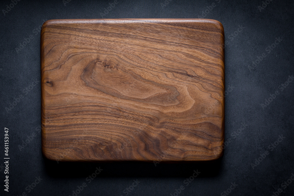 Black walnut handmade wooden chopping board. Handmade black walnut wooden  cutting board on dark tone texture background. Stock Photo | Adobe Stock