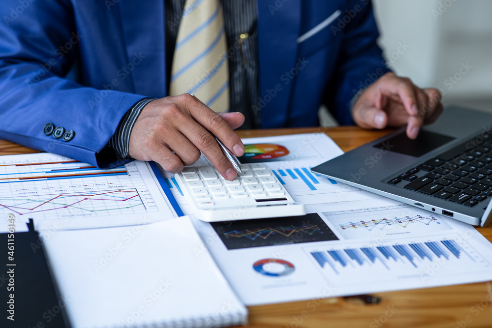 Financial Businessman analyze the graph of the company's performance to create profits and growth, Market research reports and income statistics, Financial and Accounting concept. Financial Businessman analyze the graph of the company's performance to create profits and growth, Market research reports and income statistics, Financial and Accounting concept.