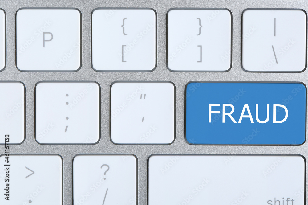 Blue button with word FRAUD on keyboard, top view Blue button with word FRAUD on keyboard, top view