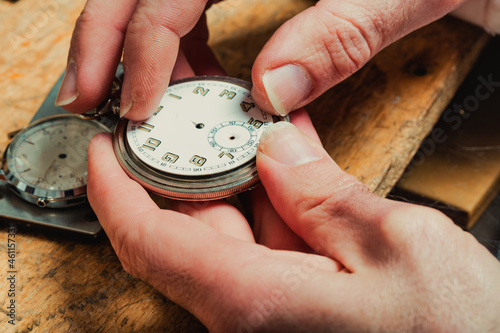 Watchmaker replacing the dial on an old watch