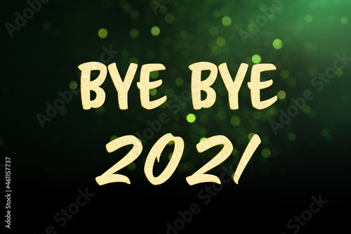 Phrase Bye Bye 2021 on green background with blurred festive lights. Bokeh effect