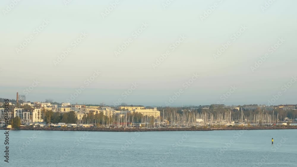Landscape view of the harbor port area in the city with lots of docking boats on the side in Helsinki Finland Landscape view of the harbor port area in the city with lots of docking boats on the side in Helsinki Finland