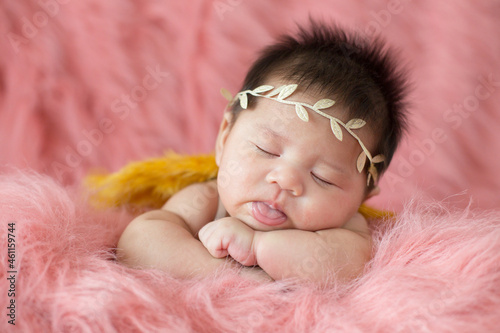 A cute newborn boy wearing a headband and small angle wing sleeping on a pink soft blanket, Infant, baby, babyhood concept and copy space - Image	