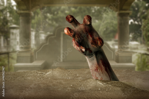 Zombie hand with blood and wound raised