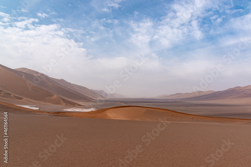 Nature and landscapes of dasht e lut or sahara desert with sand dunes and cloudy evening sky