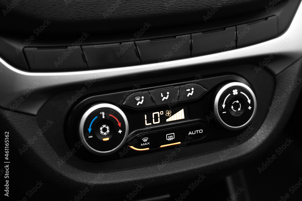  Black detail with the air conditioning button, the dashboard with information about temperature inside a car. .