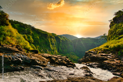 Beautiful waterfall with dramatic sky, somewhere in the Sahyadri ranges of western ghats of Maharashtra. photo