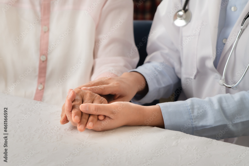Doctor hands together holding senior woman patient