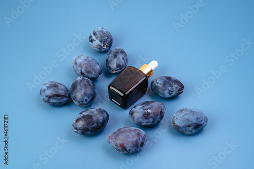 Essence for the health of the skin on the background of plums. Healthy lifestyle. Serum for men and women