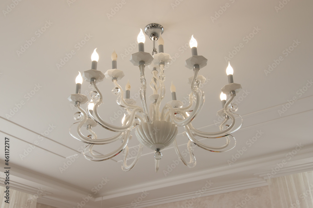 chandelier in a modern style with glowing bulbs contours and curves for a large house chandelier in a modern style with glowing bulbs contours and curves for a large house